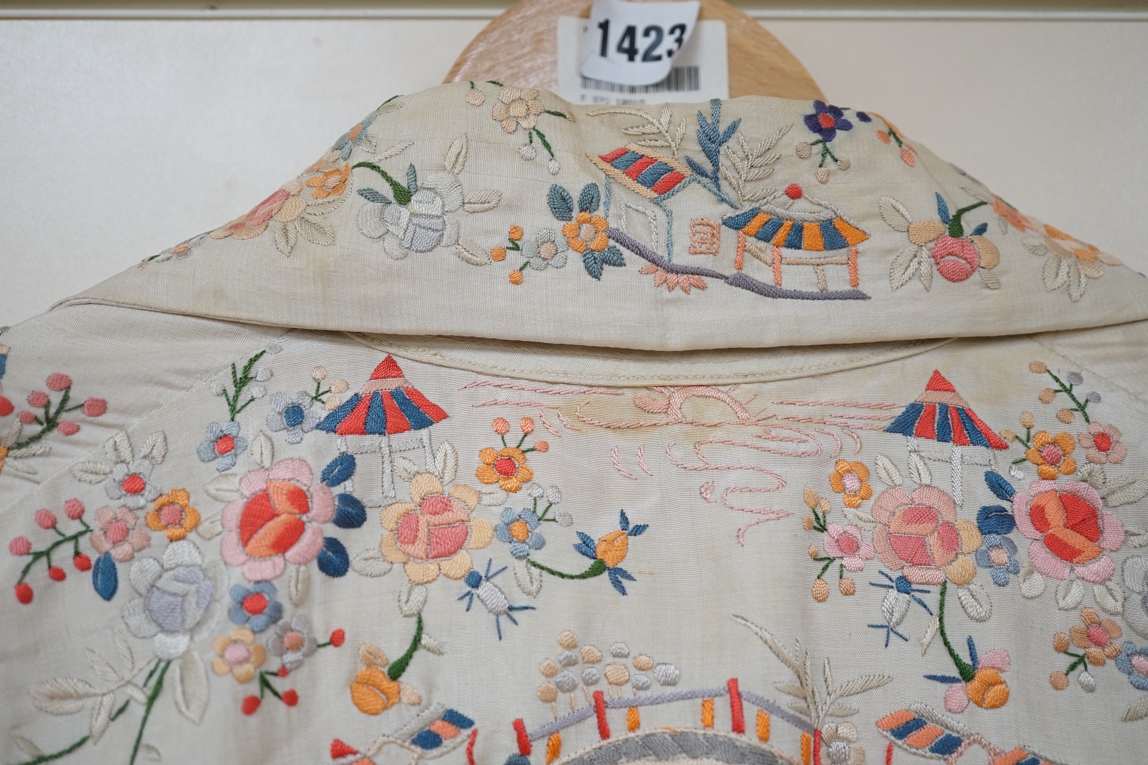 A Chinese 1930’s cream silk and multi coloured embroidered evening jacket